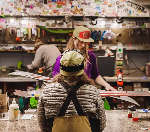 Customer getting skis serviced in the Habitat rentals and repairs shop
